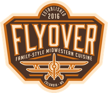 Flyover restaurant logo in brown, orange, and cream with wings and “Established 2016”