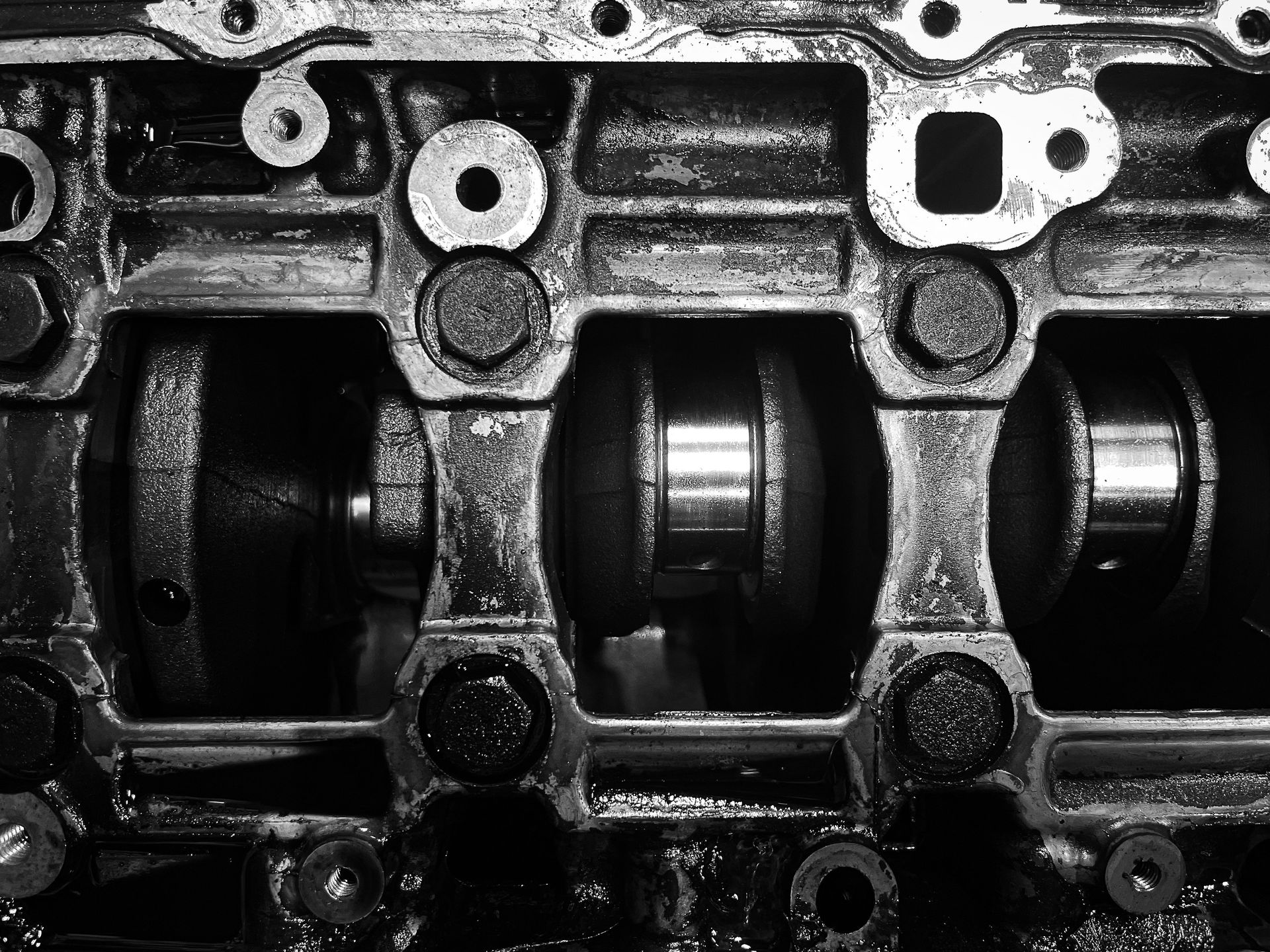 Close-up of an engine camshaft and valve train inside a metal cylinder head