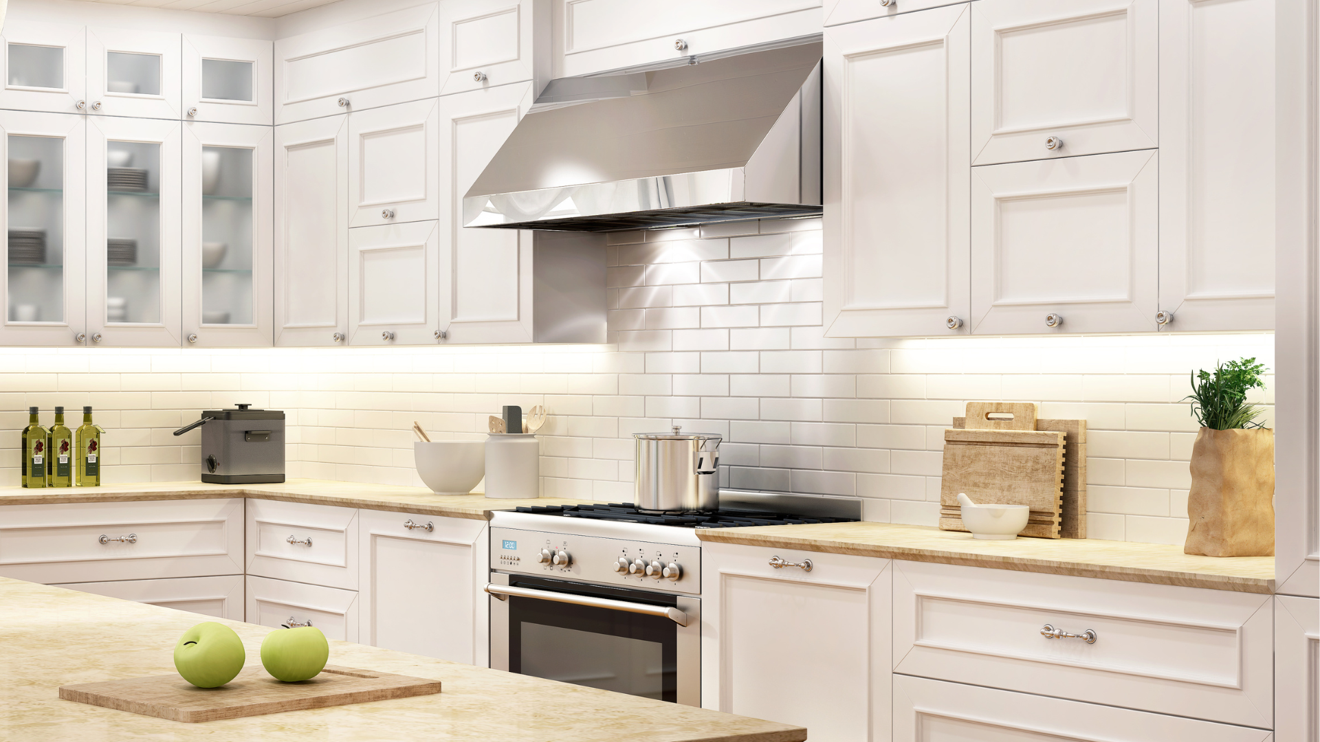 A kitchen with white cabinets , granite counter tops , stainless steel appliances and a large island.