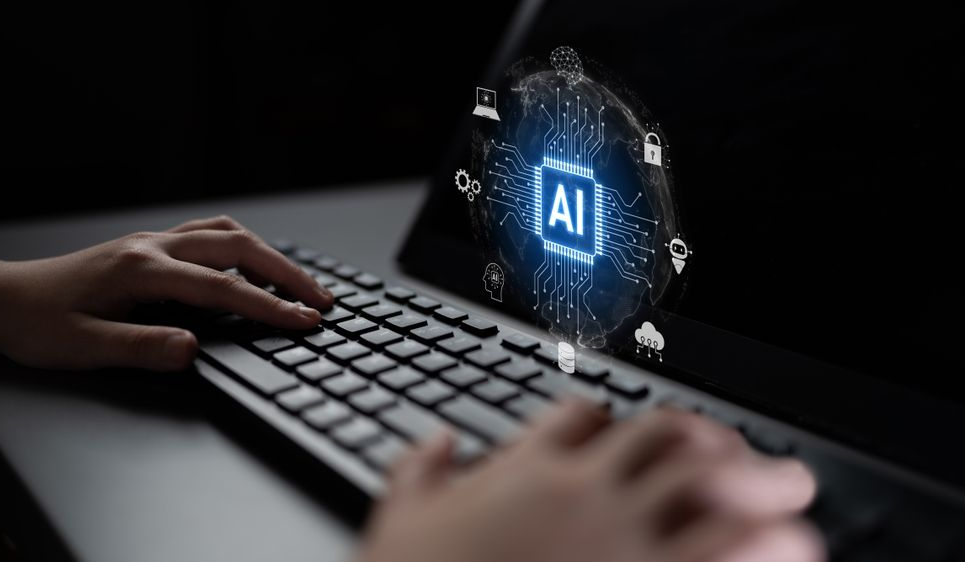 Hands typing on a keyboard with a glowing AI icon hovering above it in a dark setting