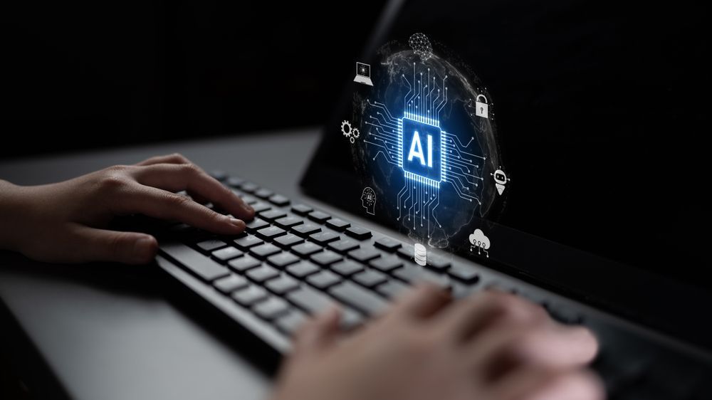 Hands typing on a keyboard in front of a glowing, holographic AI icon surrounded by digital security and data symbols.