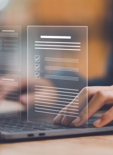 Hands typing on a laptop with a digital overlay showing document checklists and progress bars.