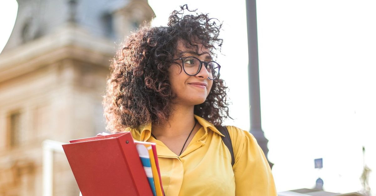 lady holding textbooks