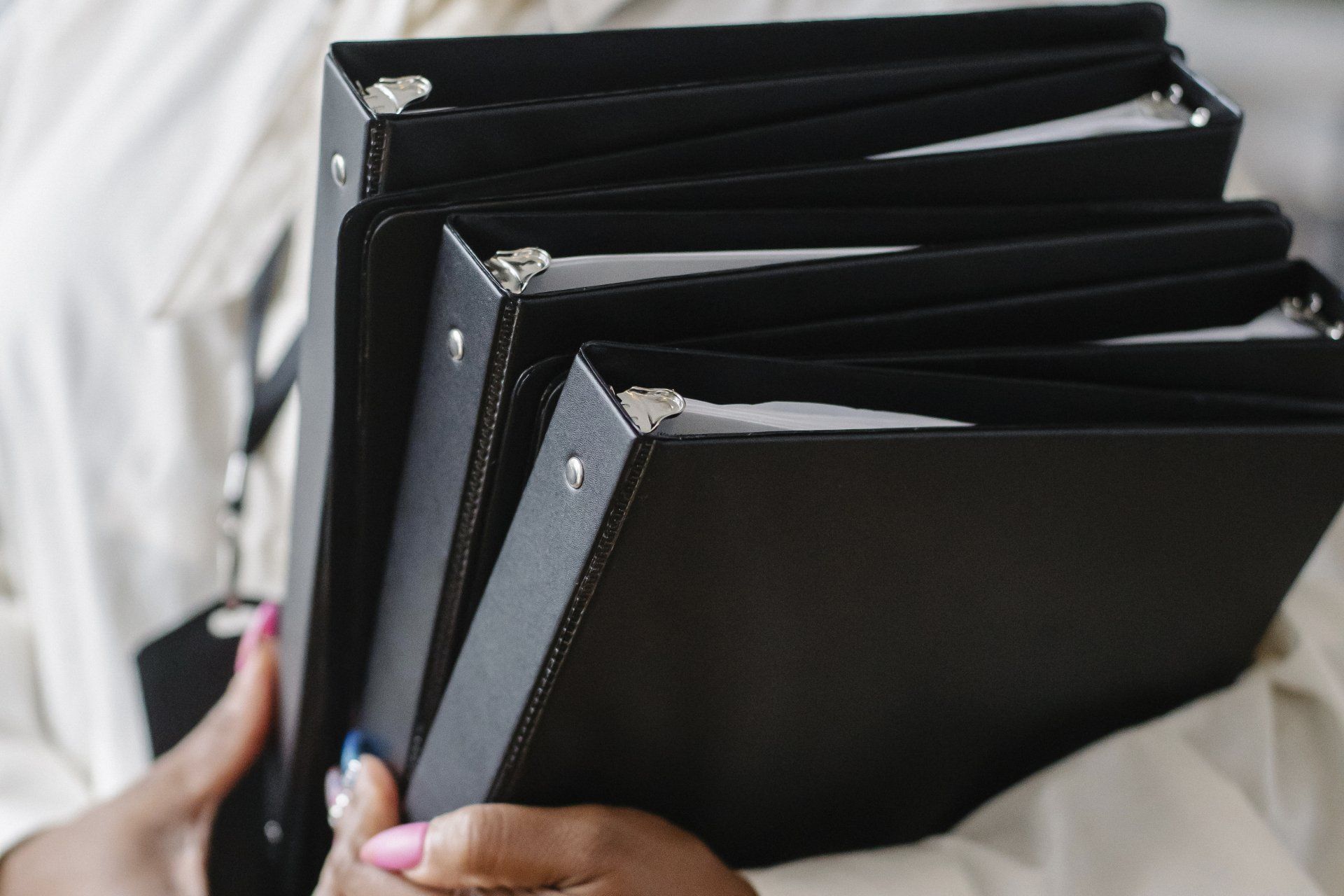 image of woman holding bound documents in a binder