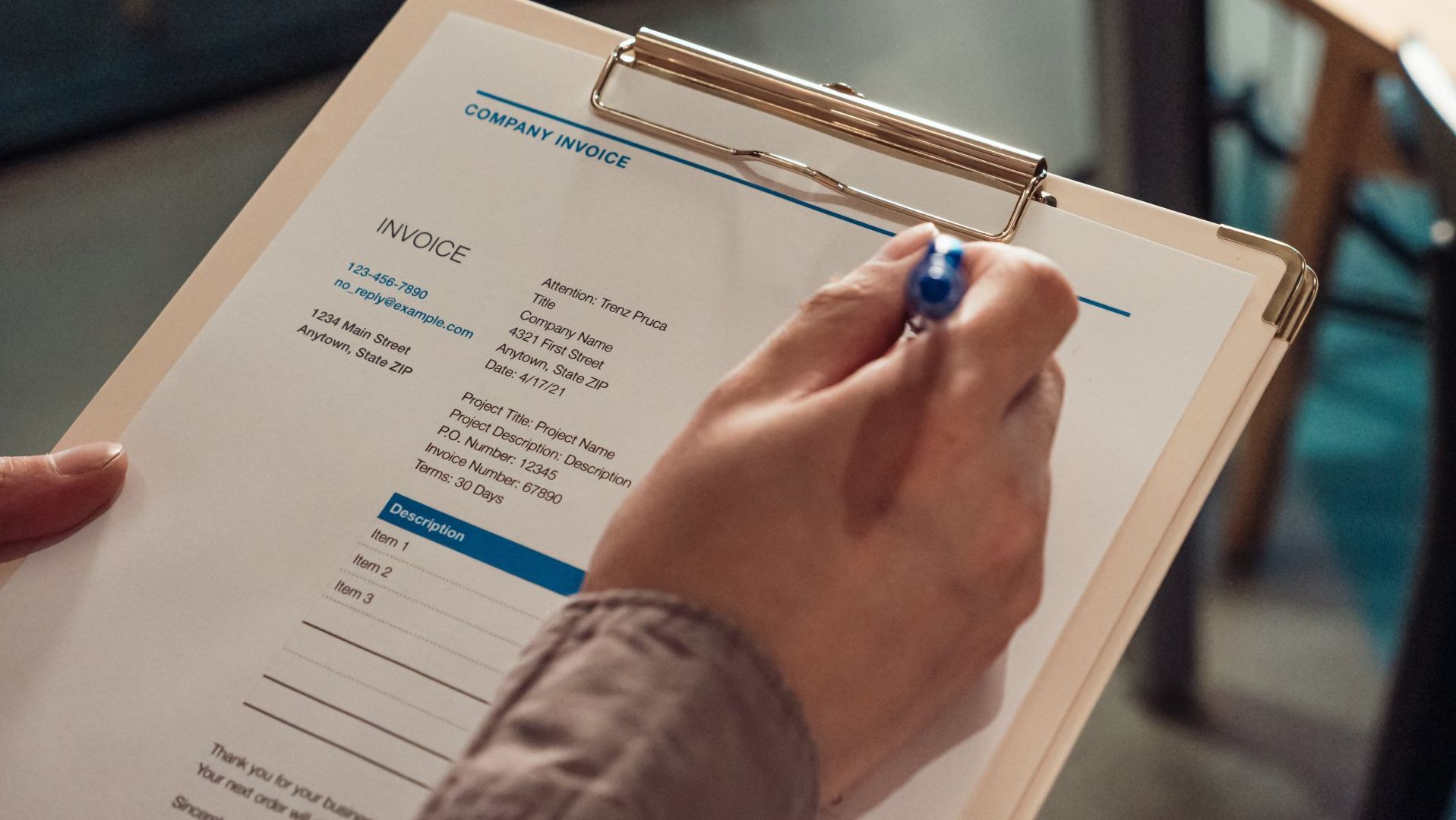 image of man handwriting data on paper forms