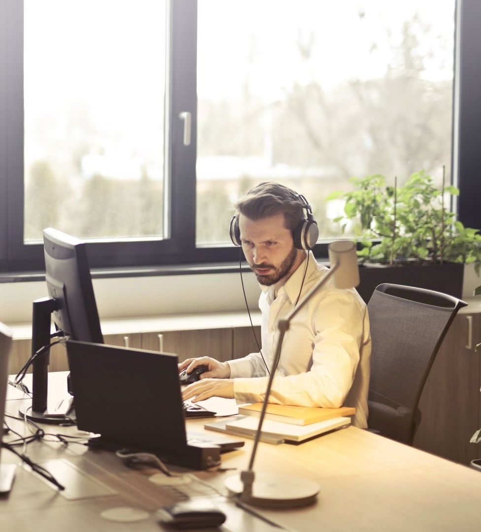 image of man on a headset with computer