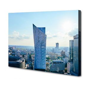 Skyline with a blue glass skyscraper above a cityscape on a sunny day