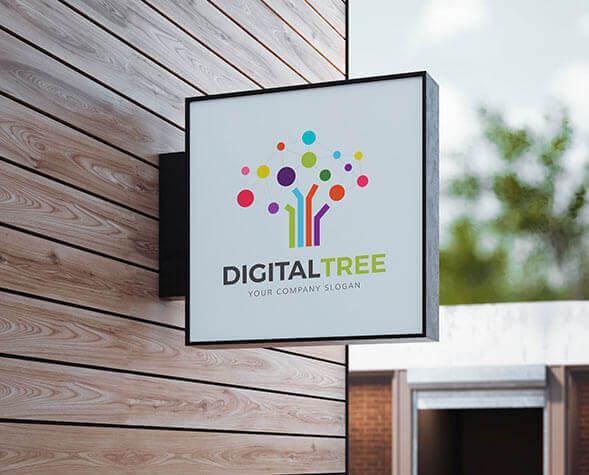 Square “DIGITALTREE” sign with colorful tree logo mounted on a wooden wall outdoors
