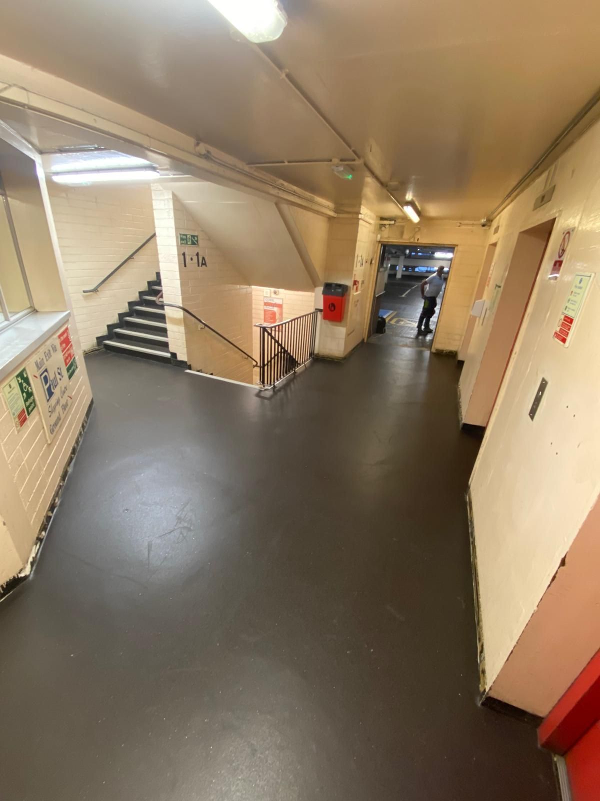 Indoor hallway with stairs, signage for 