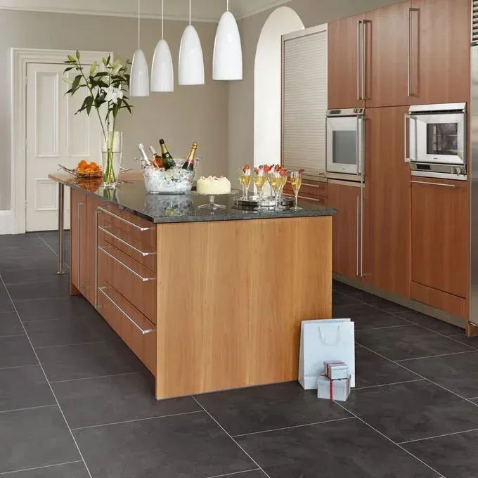 A kitchen with a large wooden island in the middle