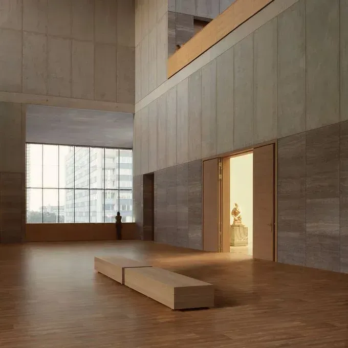 A large room with a statue in the background