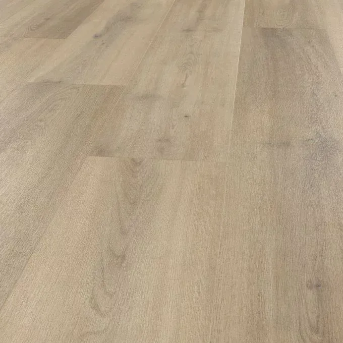 A bottle and a flower on a wooden floor