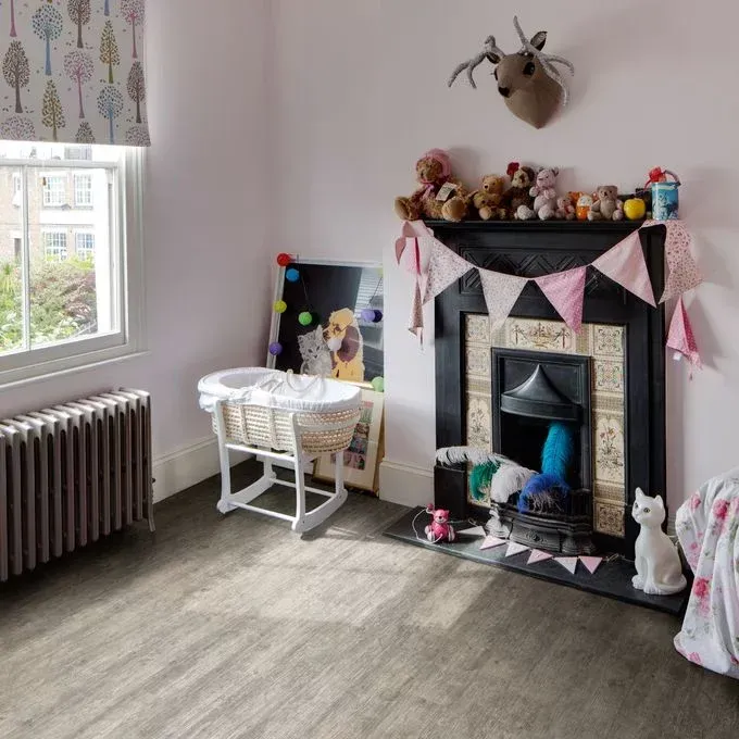 A child 's room with a fireplace and a crib