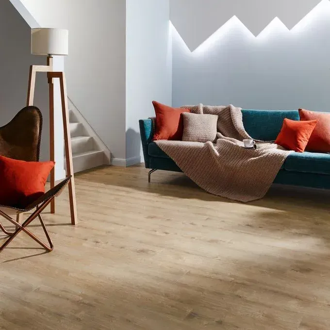 A living room with a blue couch and red pillows
