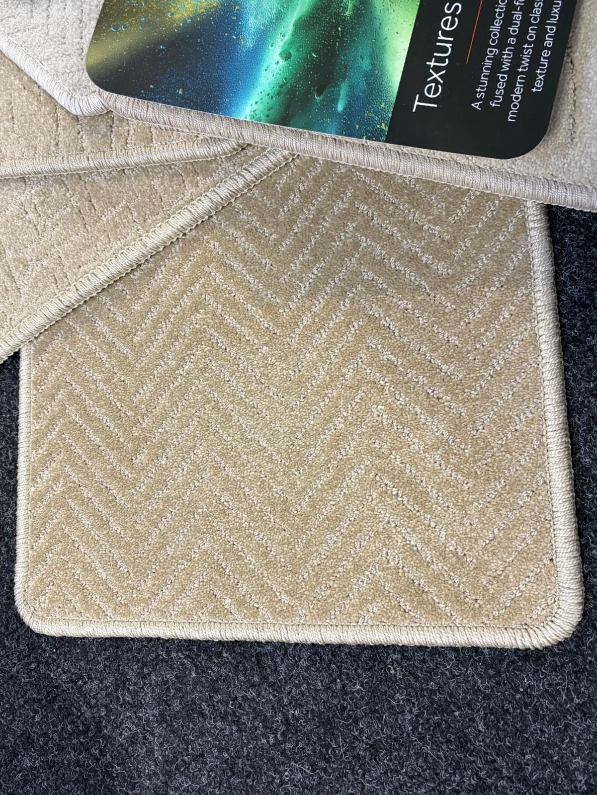 Carpet swatches in various neutral shades arranged around a product label on a dark gray carpet.