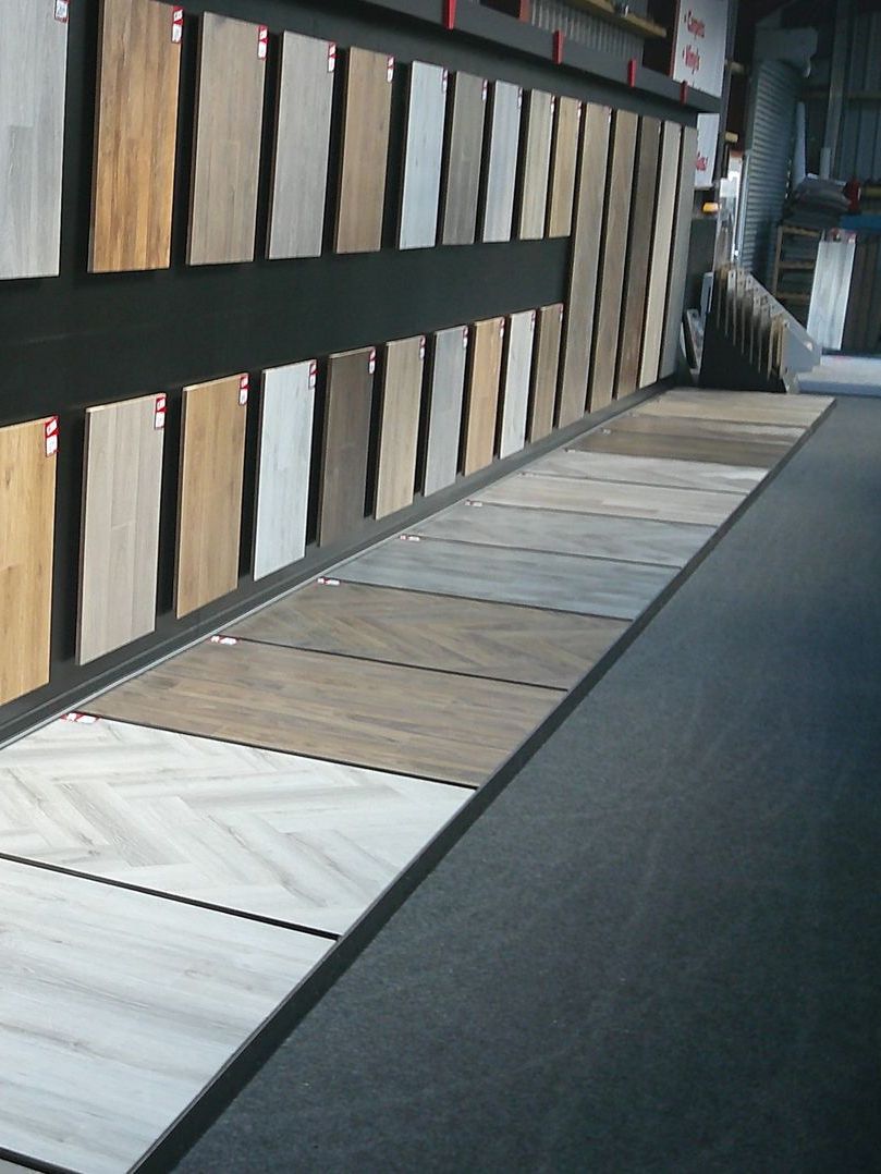 A row of wooden boards are lined up on a wall in a store.