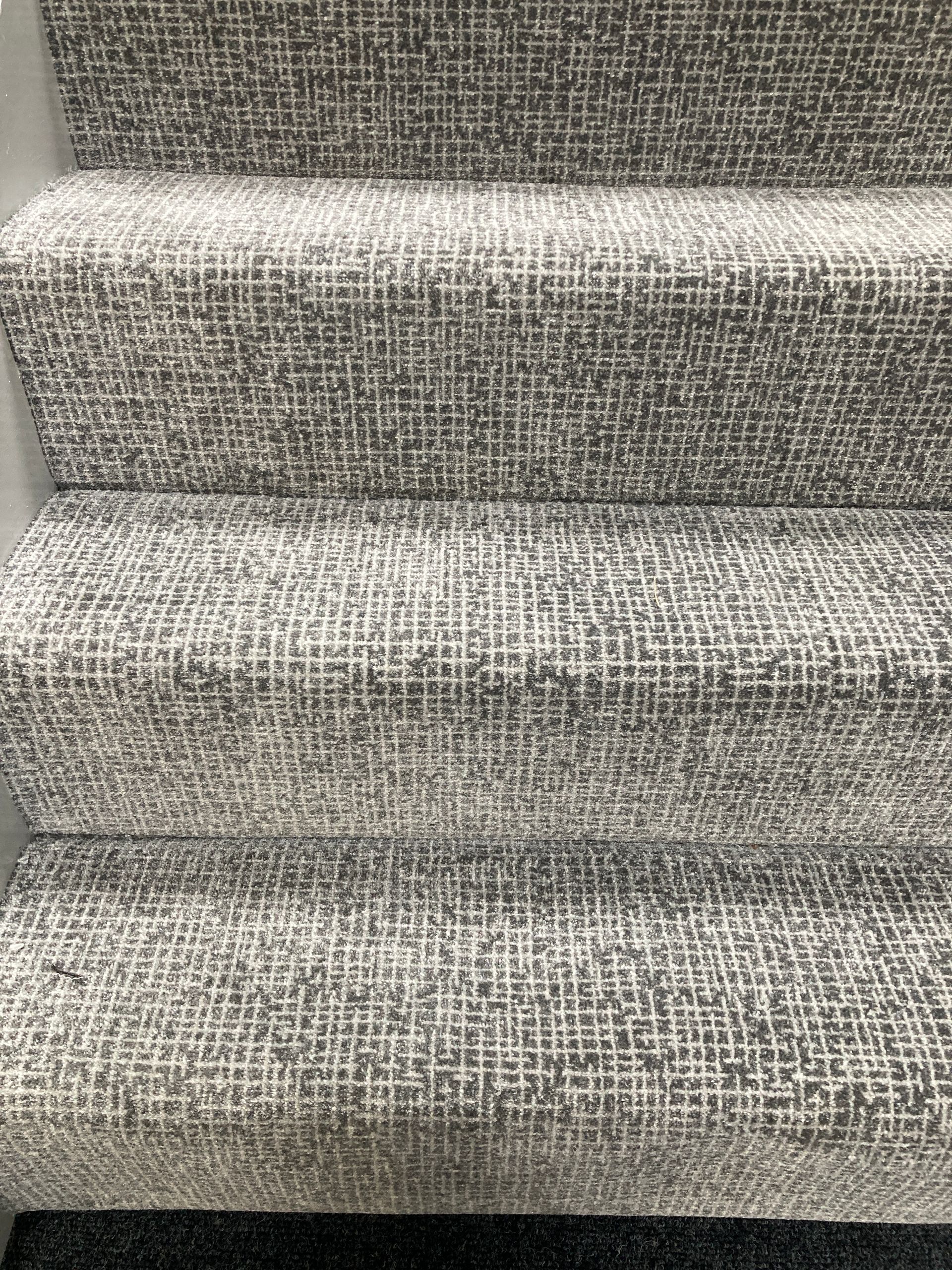 A close up of a staircase with a carpet on it.