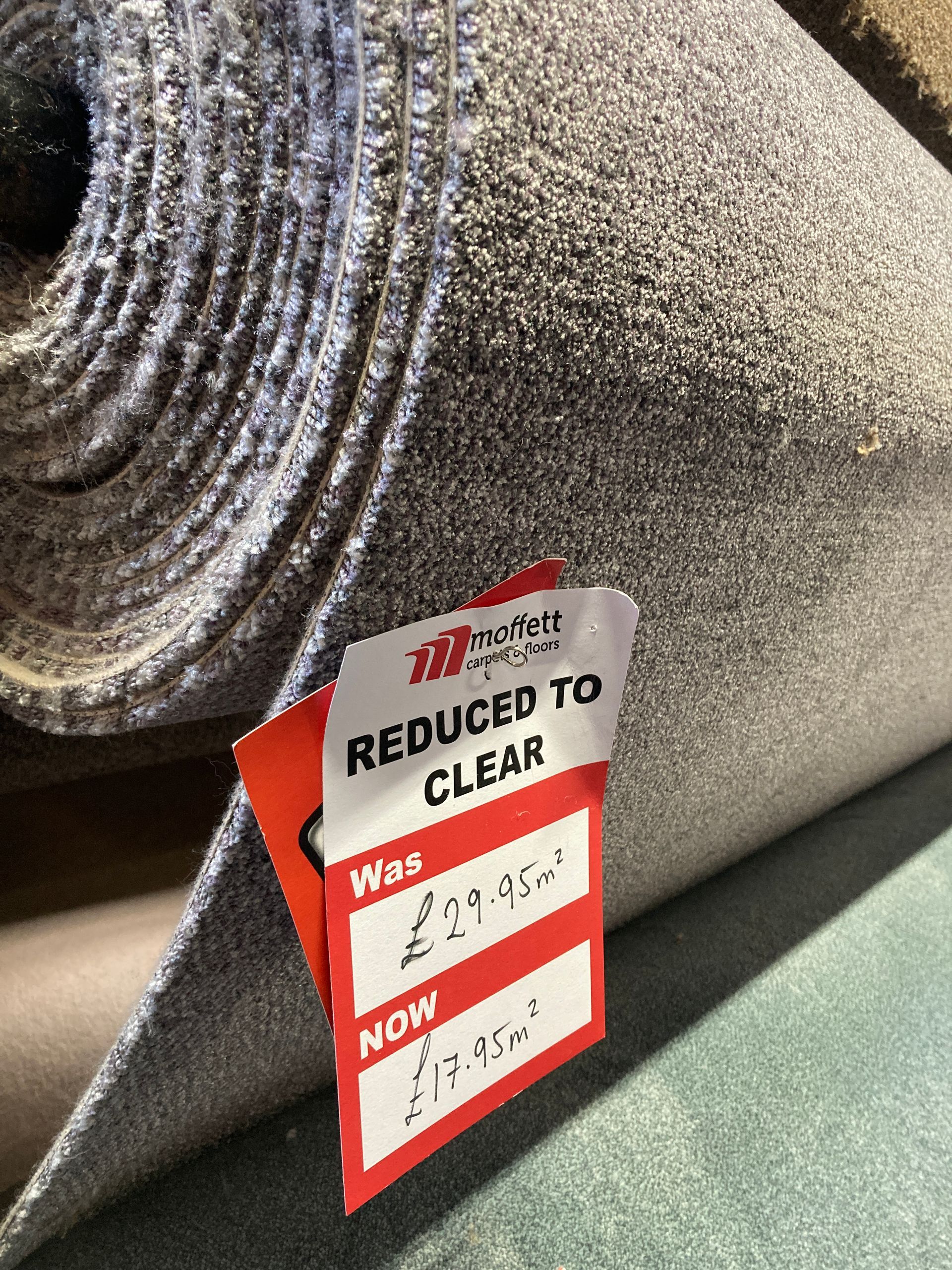 Roll of grey carpet with a red 