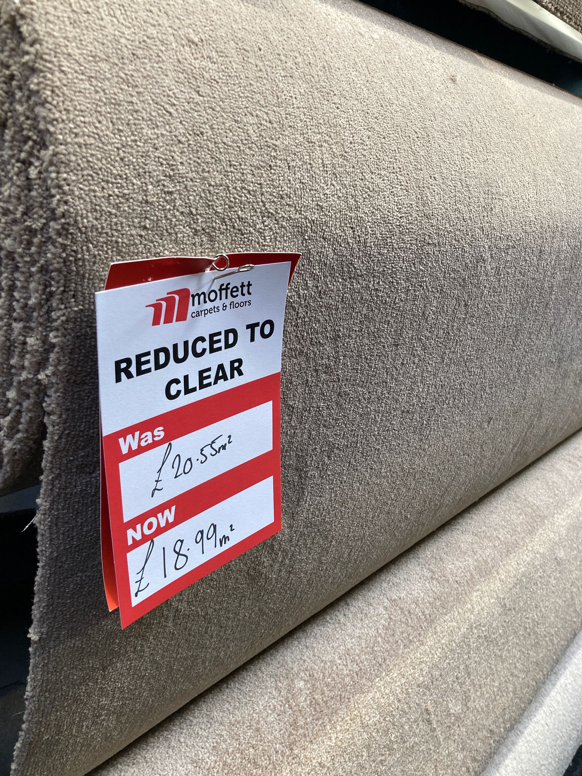Roll of beige carpet with a 