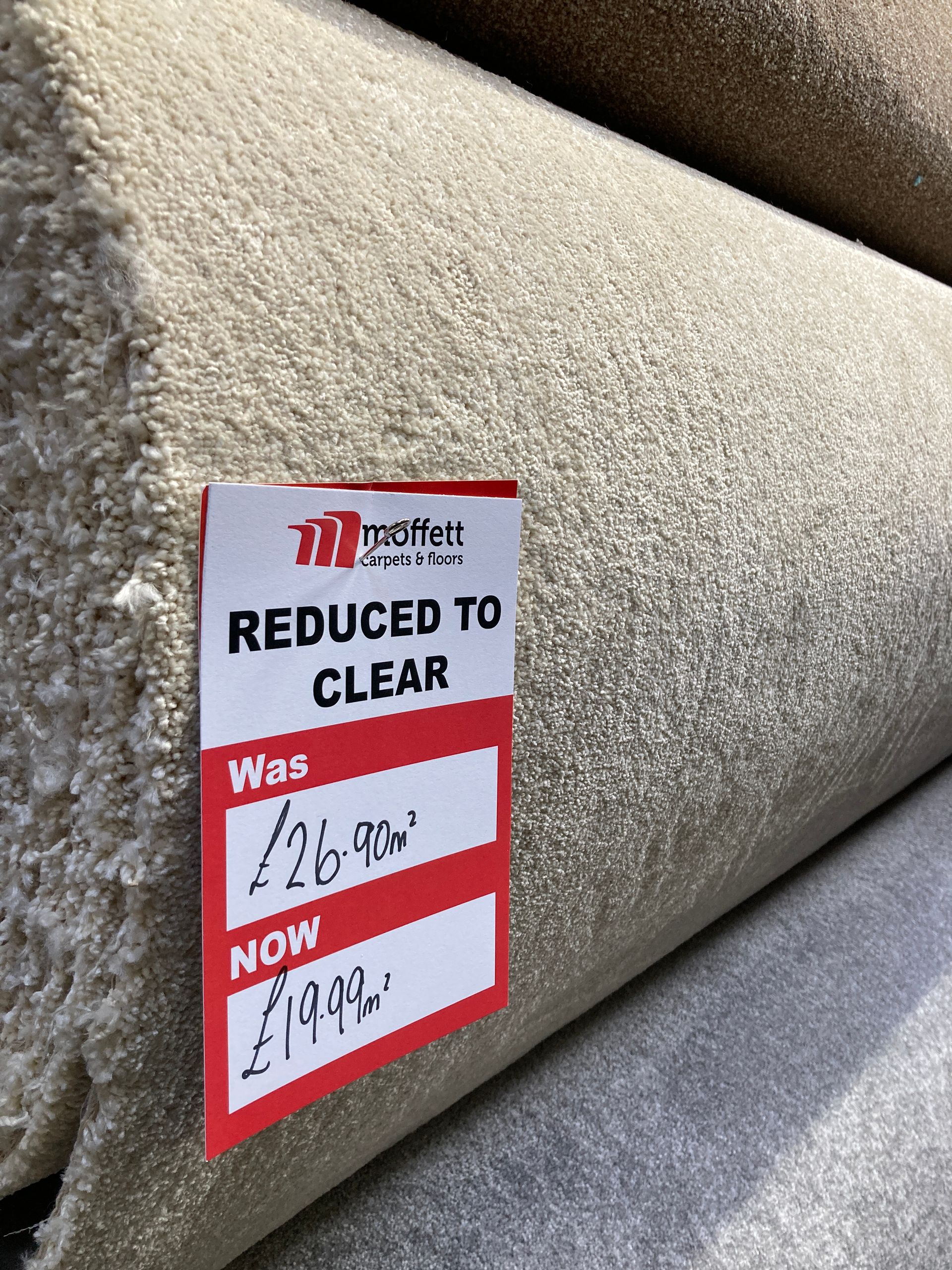 Rolls of beige carpet with a 