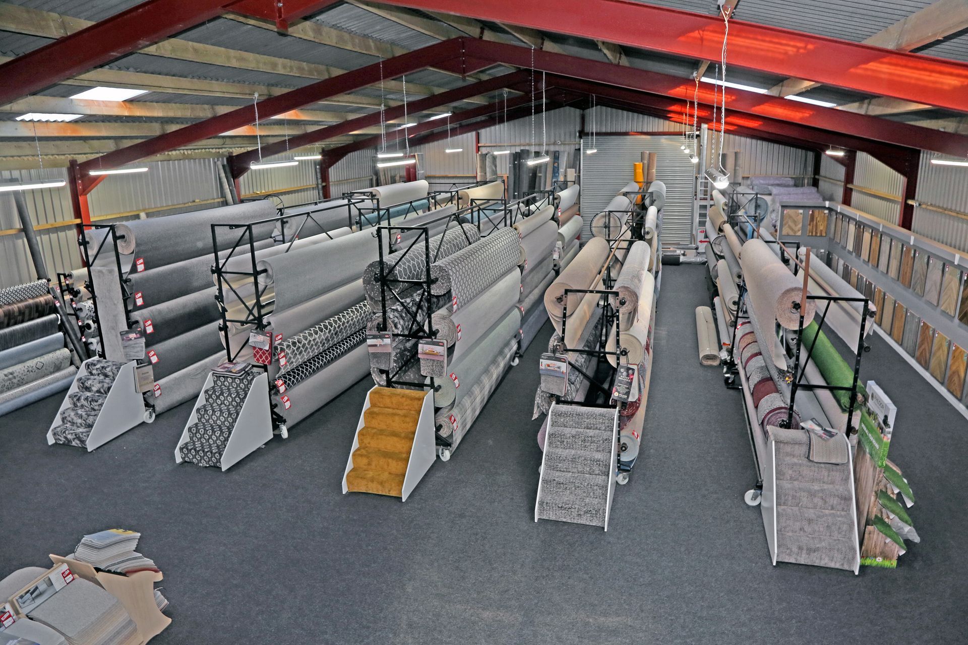 A large warehouse filled with lots of rolls of fabric