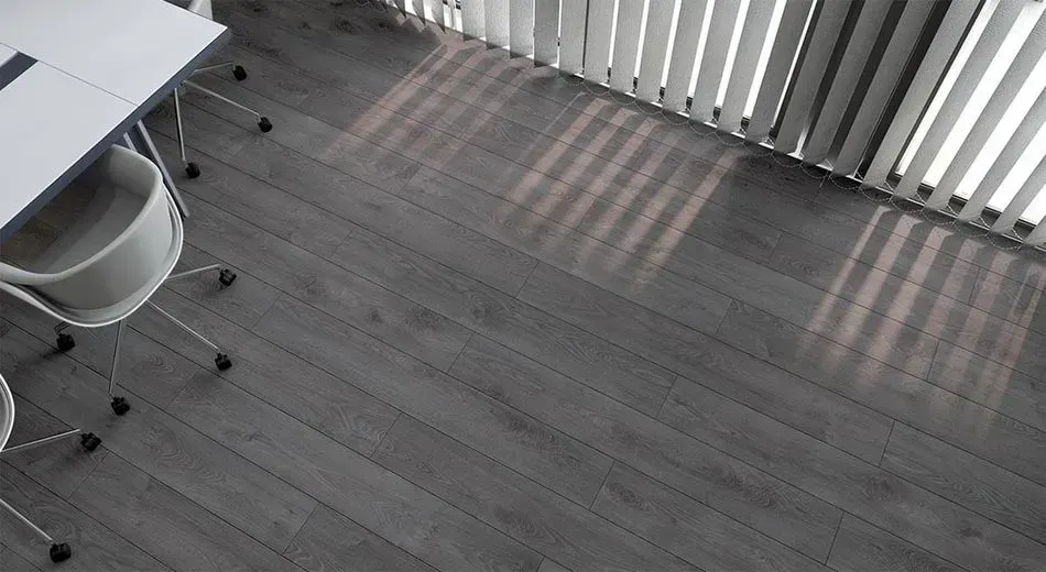 There is a table and chairs in the room with a wooden floor.