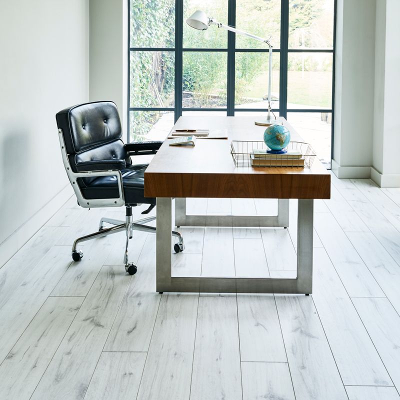 A desk with a chair and a globe on it