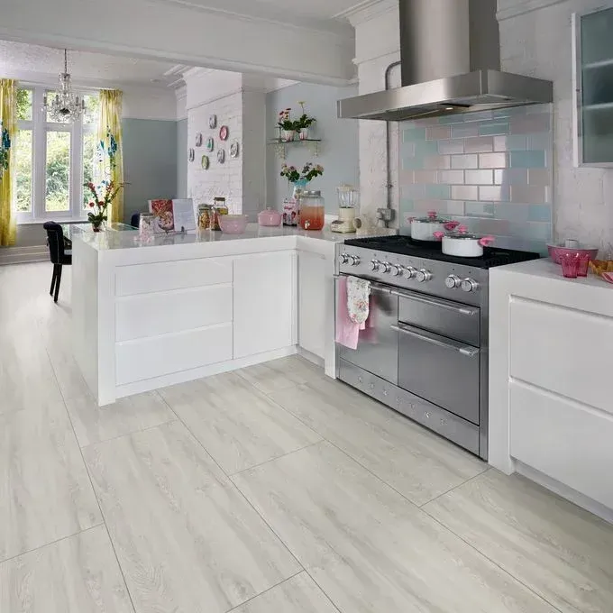 A kitchen with a stove , oven , and hood.