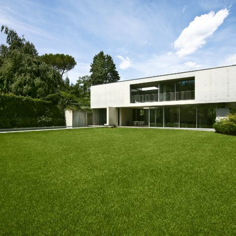 A large house with a lush green lawn in front of it