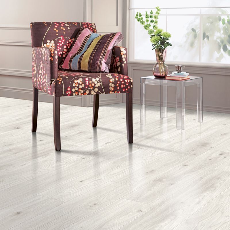 A dining room with a table and chairs and a wooden floor