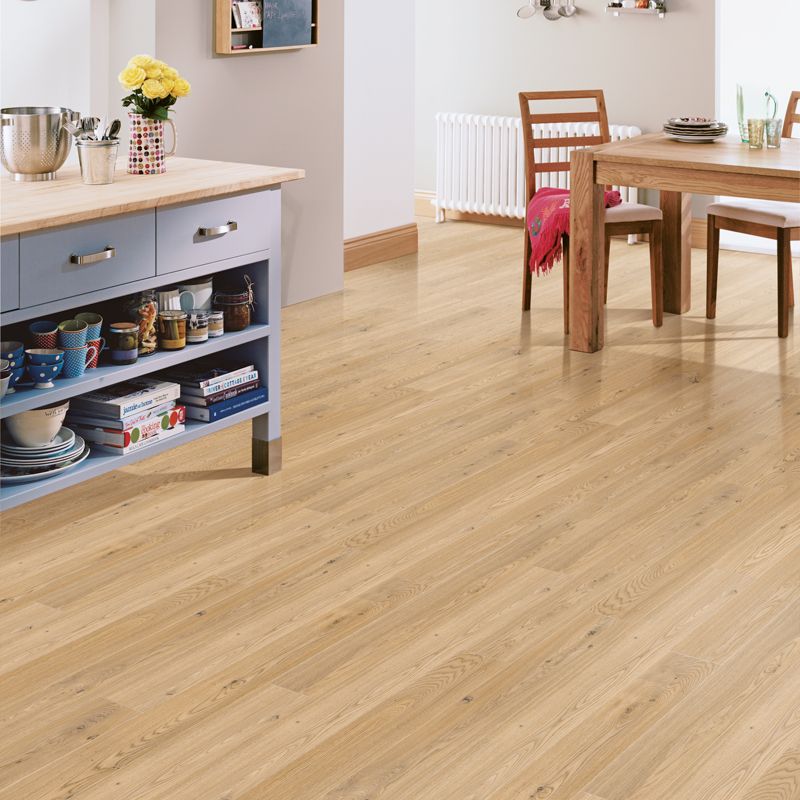 A dining room with a table and chairs and a wooden floor