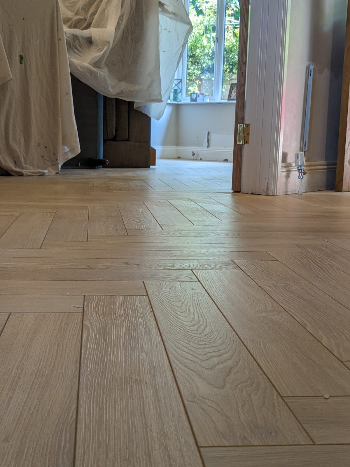 A close up of a wooden floor in a room.