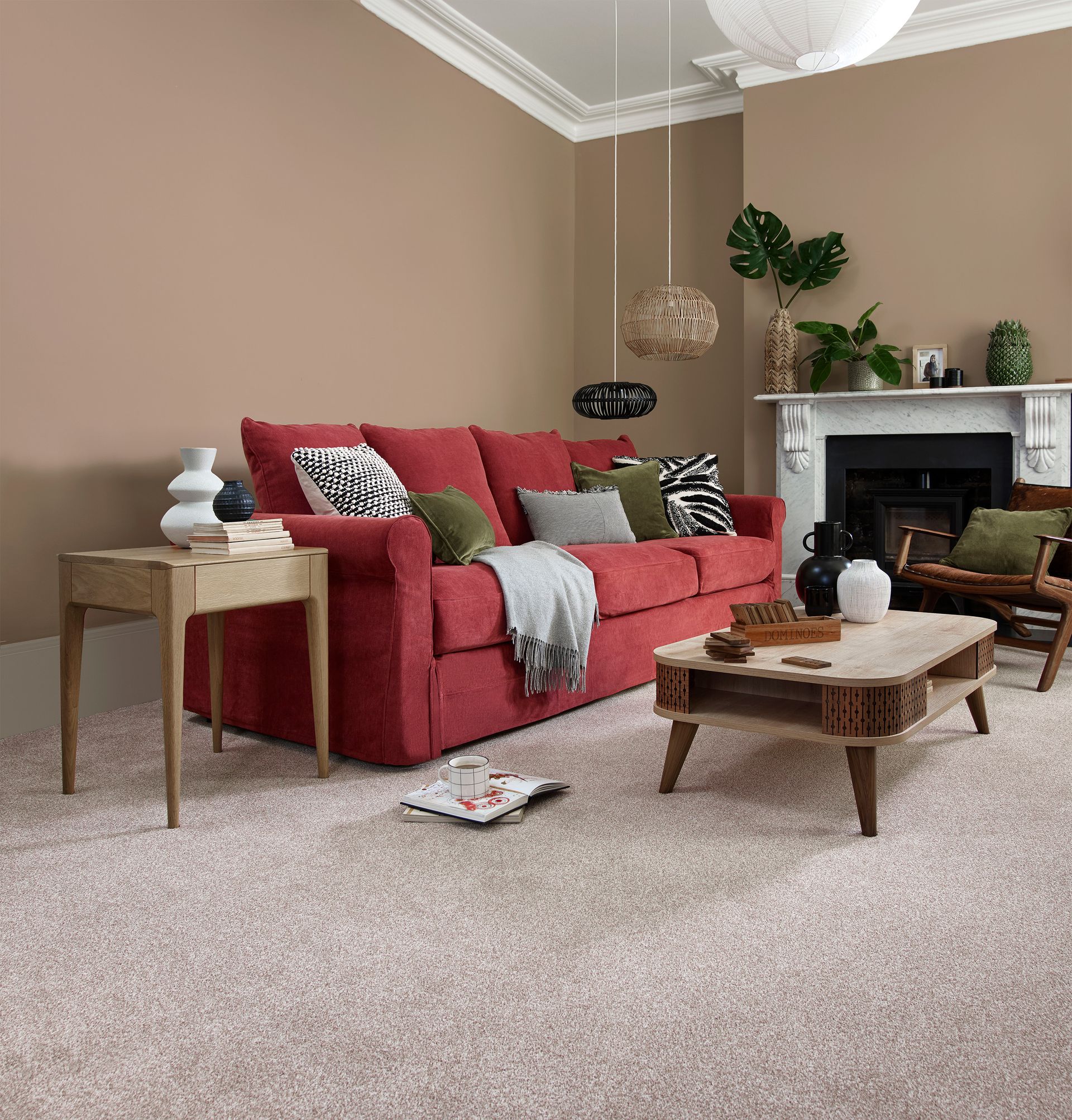 A living room with a red couch and a coffee table