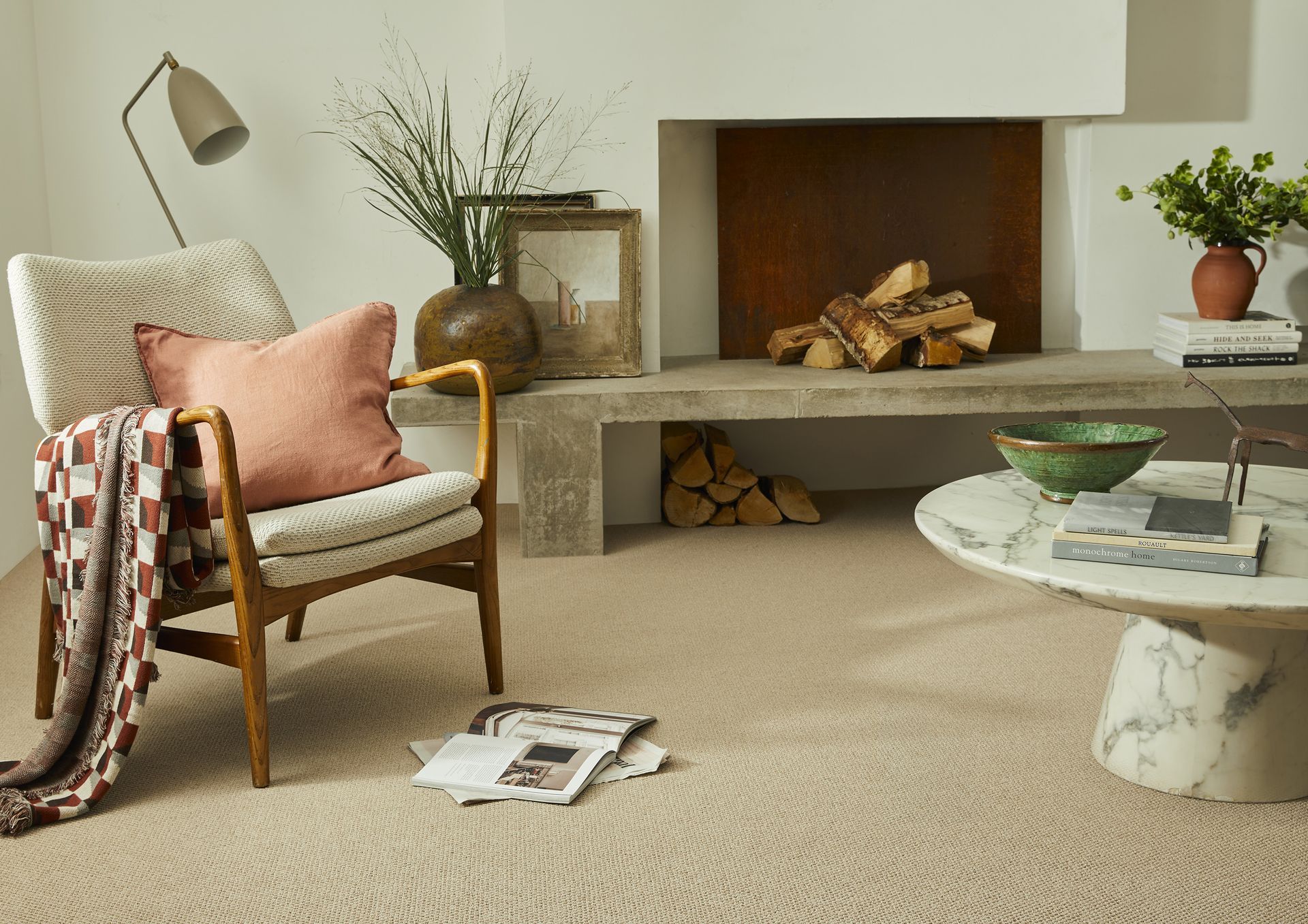 A living room with a chair , coffee table and fireplace.
