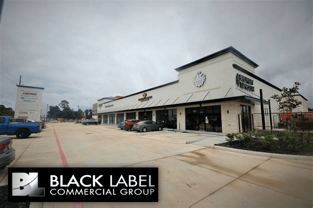 A black label commercial group building with cars parked in front of it