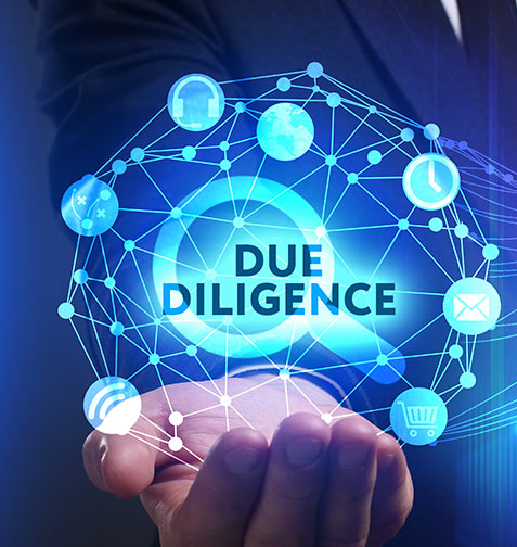 A man in a suit is holding a screen that says due diligence