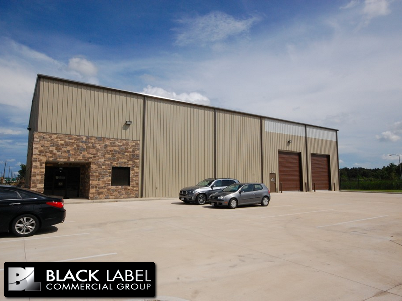 A black label commercial group building with cars parked in front of it