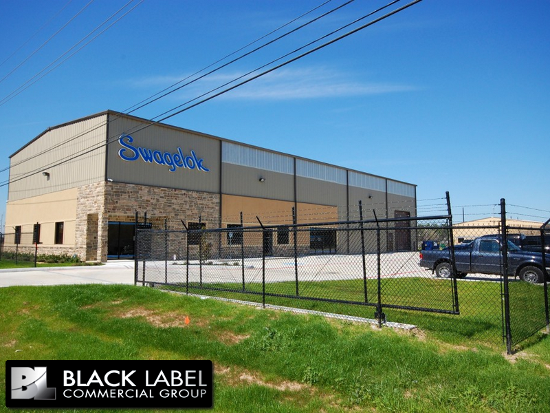A black label commercial group building with a fence around it