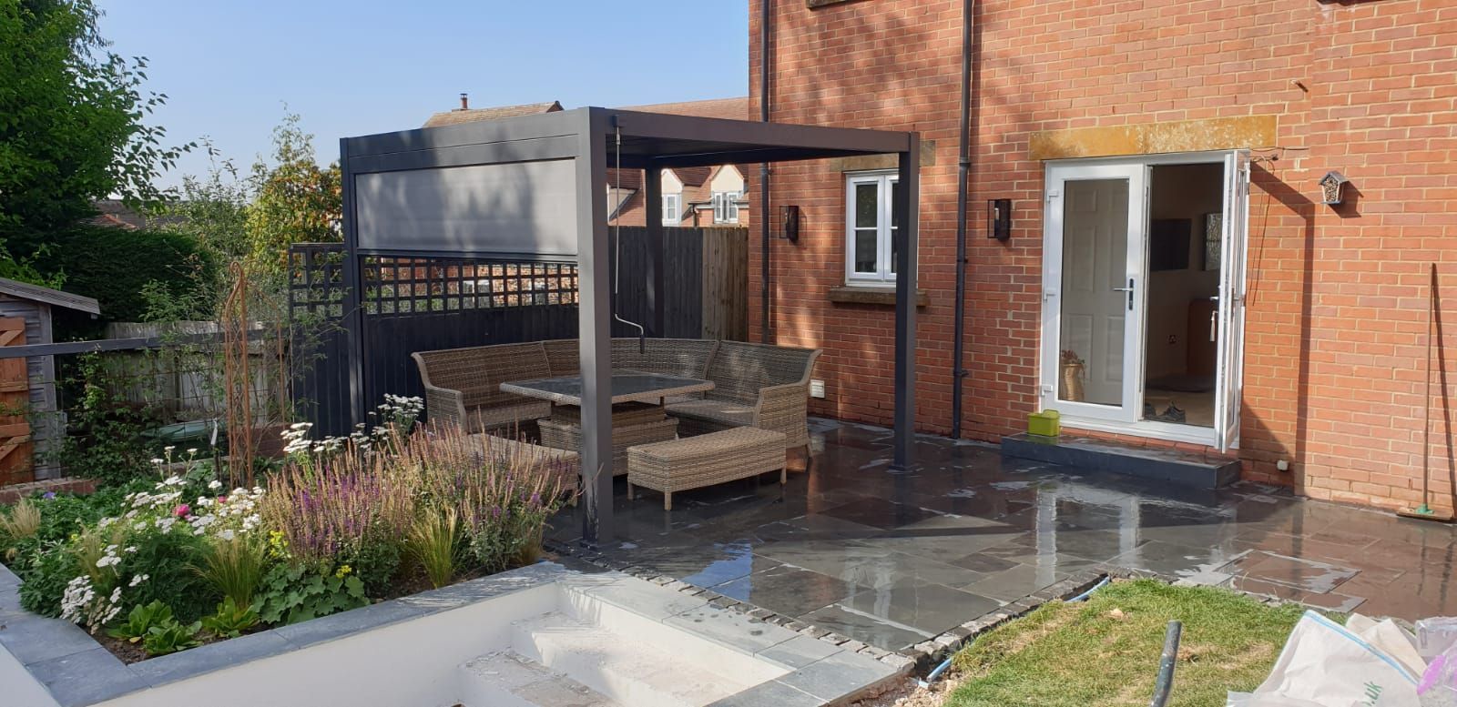 Garden design, suburban, urban, modern, black pergola, dining terrace, patio, stone paving, planting, wildlife-friendly