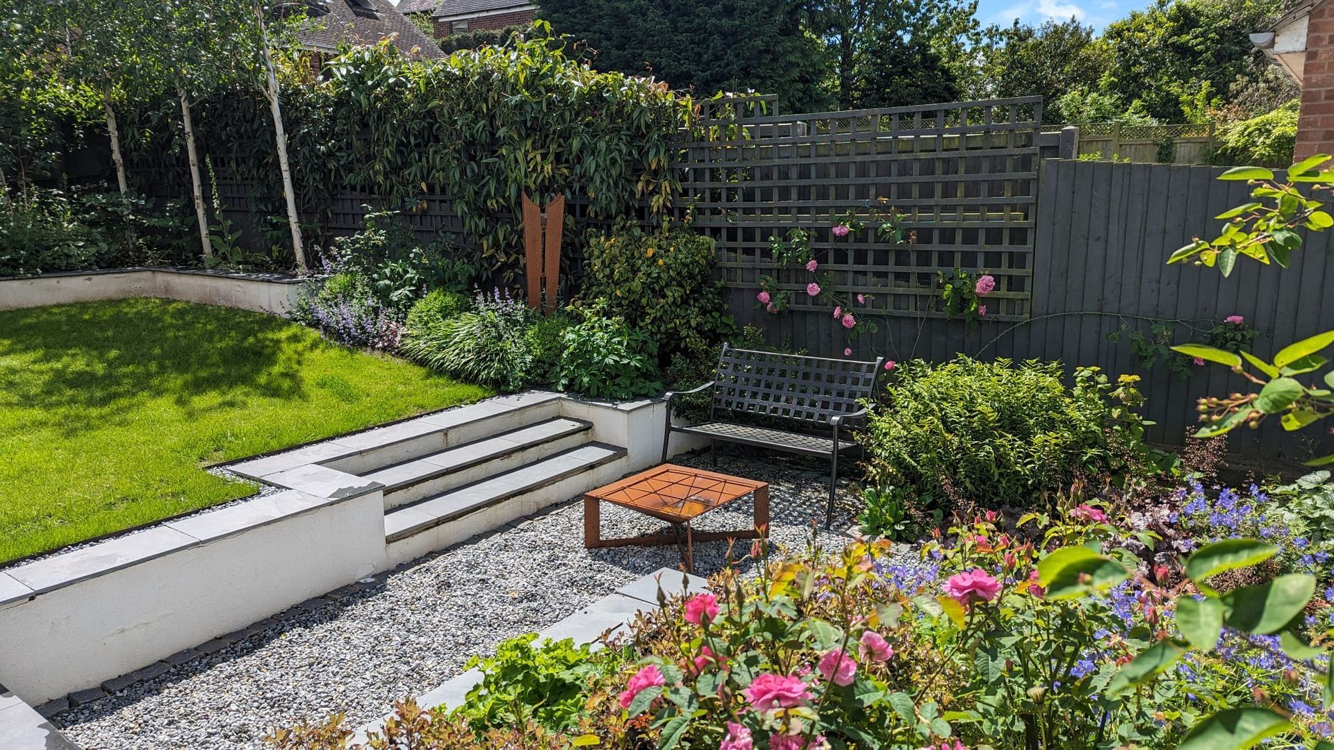 Garden design, suburban, urban, planting, wildlife-friendly, trellis fence, cottage, rendered wall, gravel, lawn, fire pit