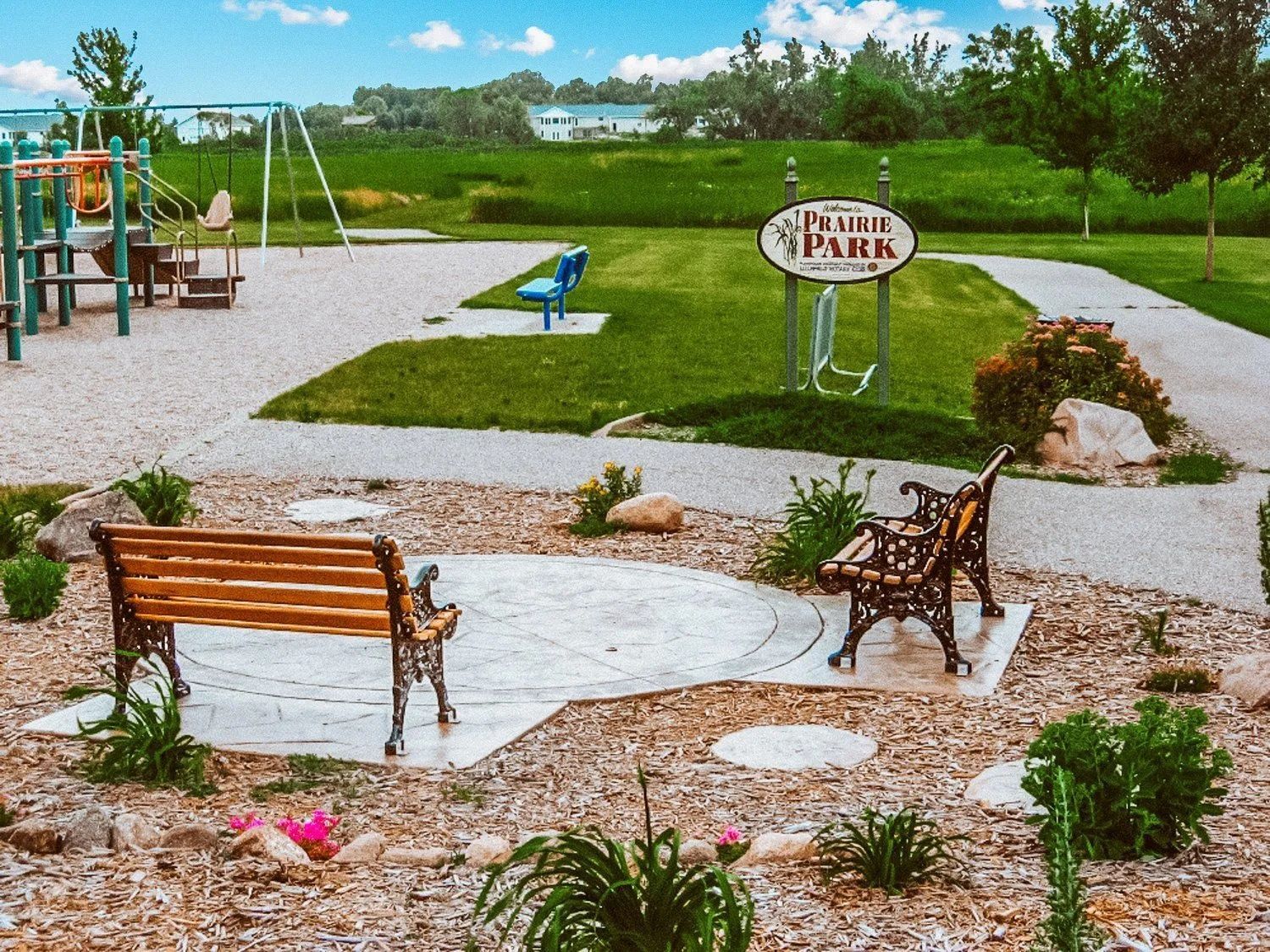 Park with playground, benches, sign