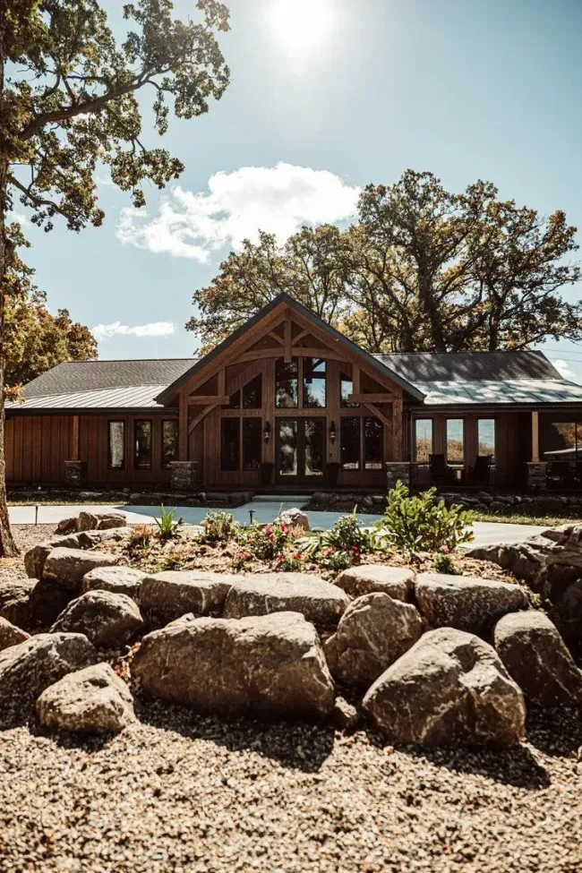 Hardscaping and landscaping services consisting of a rock garden and plants completed at a large wood cabin.