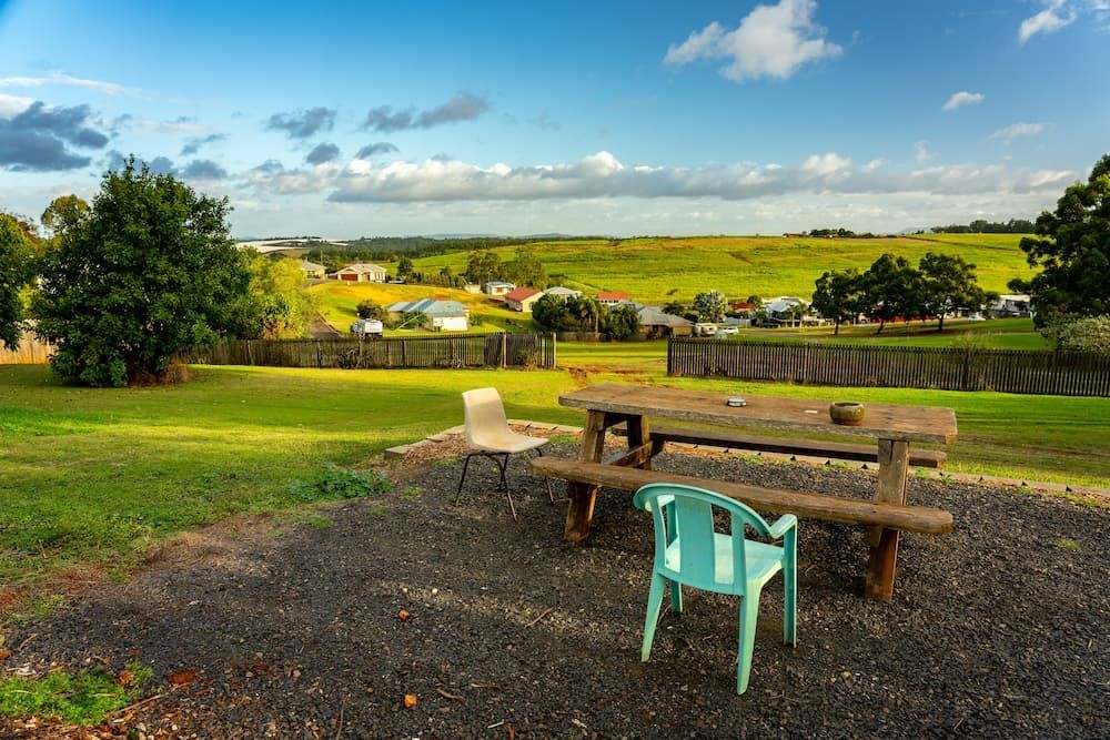 There is a Picnic Table and Chairs in the Middle of a Field — Bargara Removals in Childers, QLD