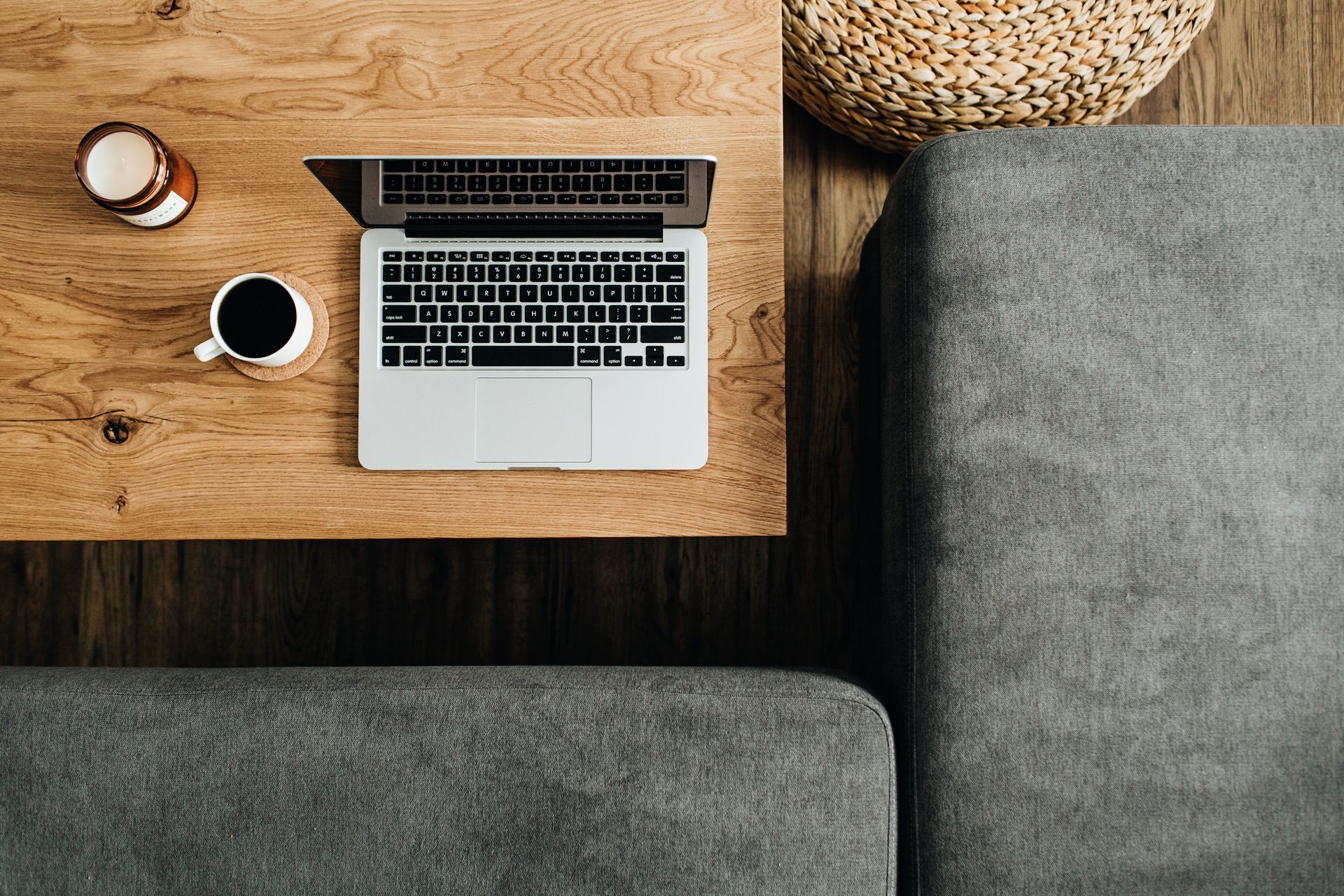 Woman sitting at a table looking at her laptop