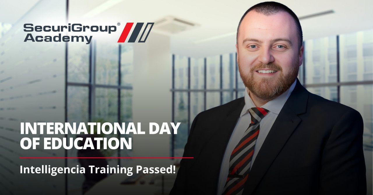 A man in a suit and striped tie smiles in front of a SecuriGroup Academy graphic celebrating International Day of Education.