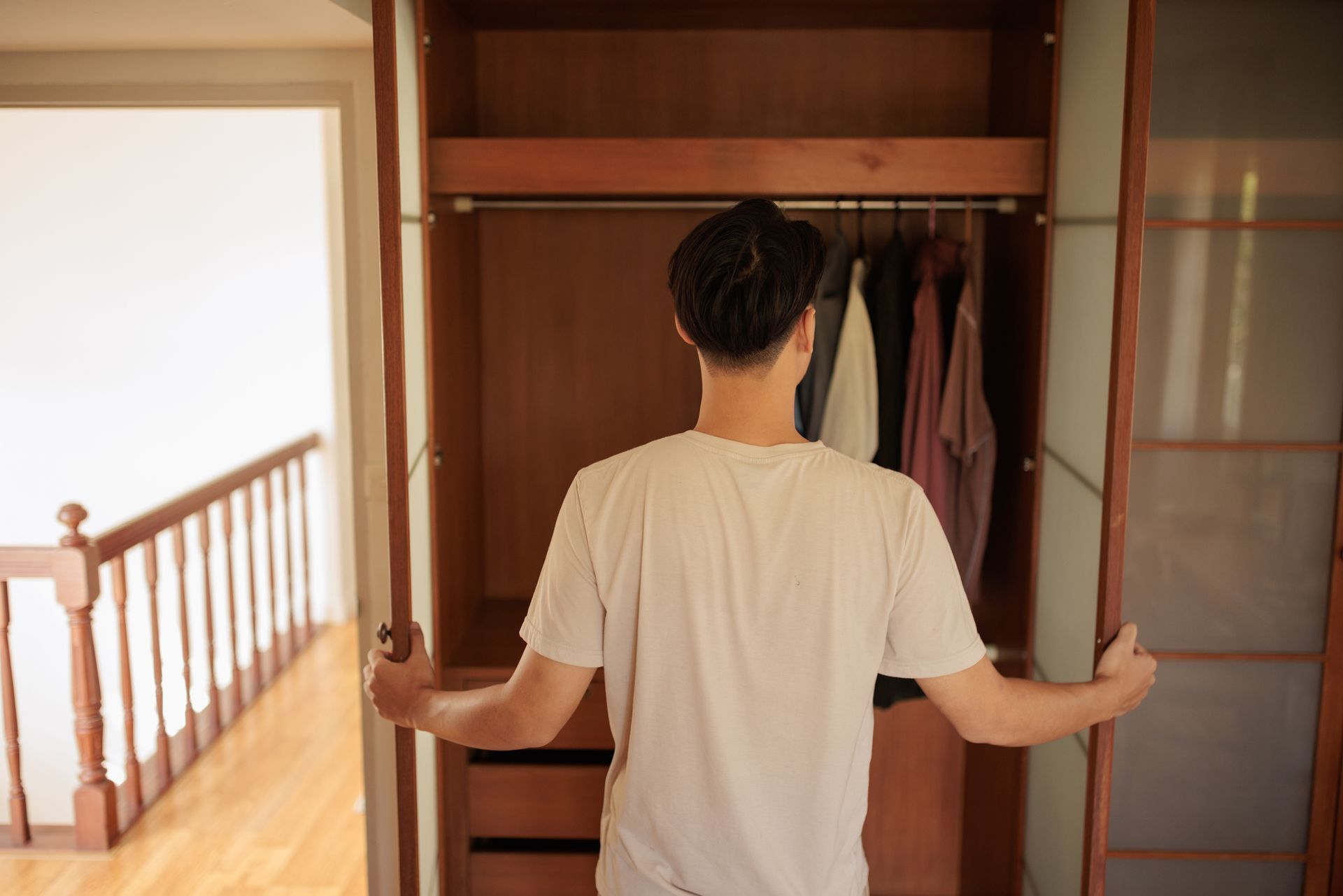 Man opening wood closet