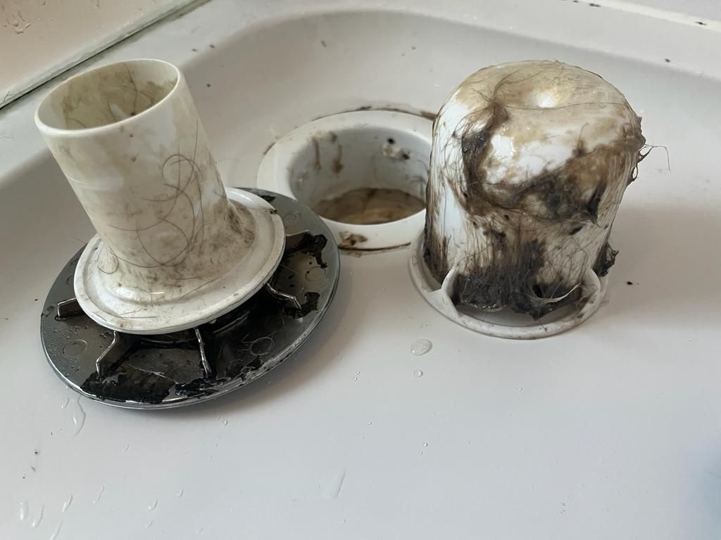 A dirty shower plug hole before cleaning
