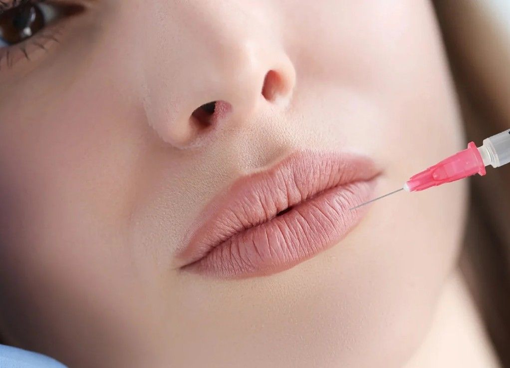 a client receiving a lip filler injection at Signature Aesthetics