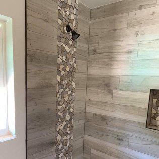 A shower with wooden tiles and a shower head.