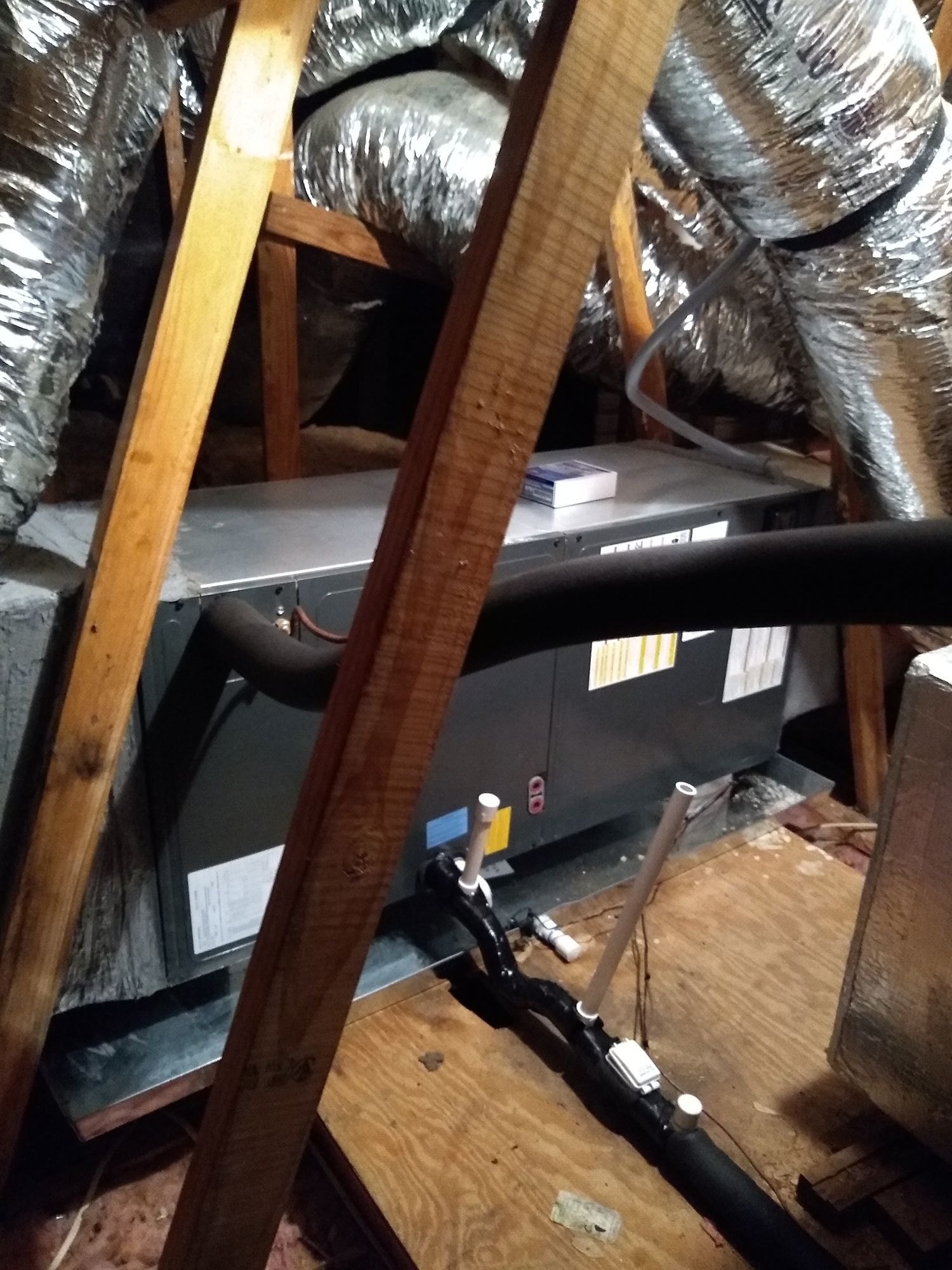 There is a ventilation system in the attic of a house.